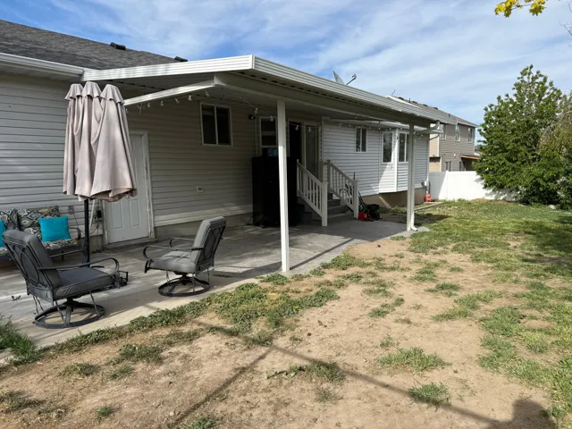 Rear view of house featuring a patio area and entry steps