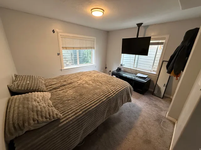 Bedroom featuring carpet floors and baseboards