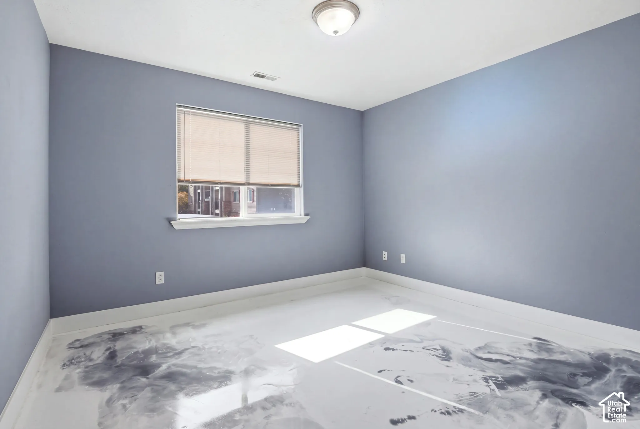 Interior space featuring custom marbled epoxy flooring, neutral-toned wall paint, and a single-window configuration with horizontal blinds