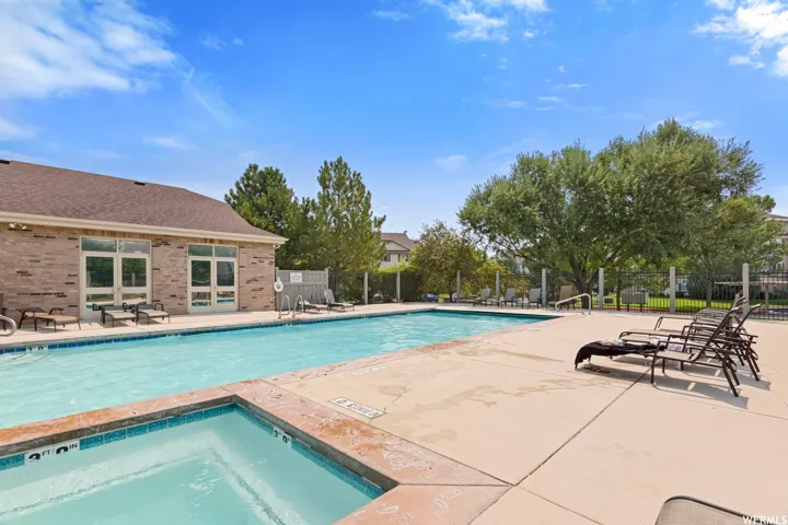Community pool with a patio and a community hot tub