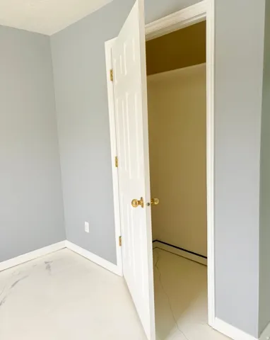 Unfurnished bedroom with concrete flooring