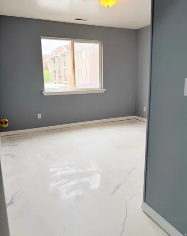 Spare room featuring concrete floors and a textured ceiling