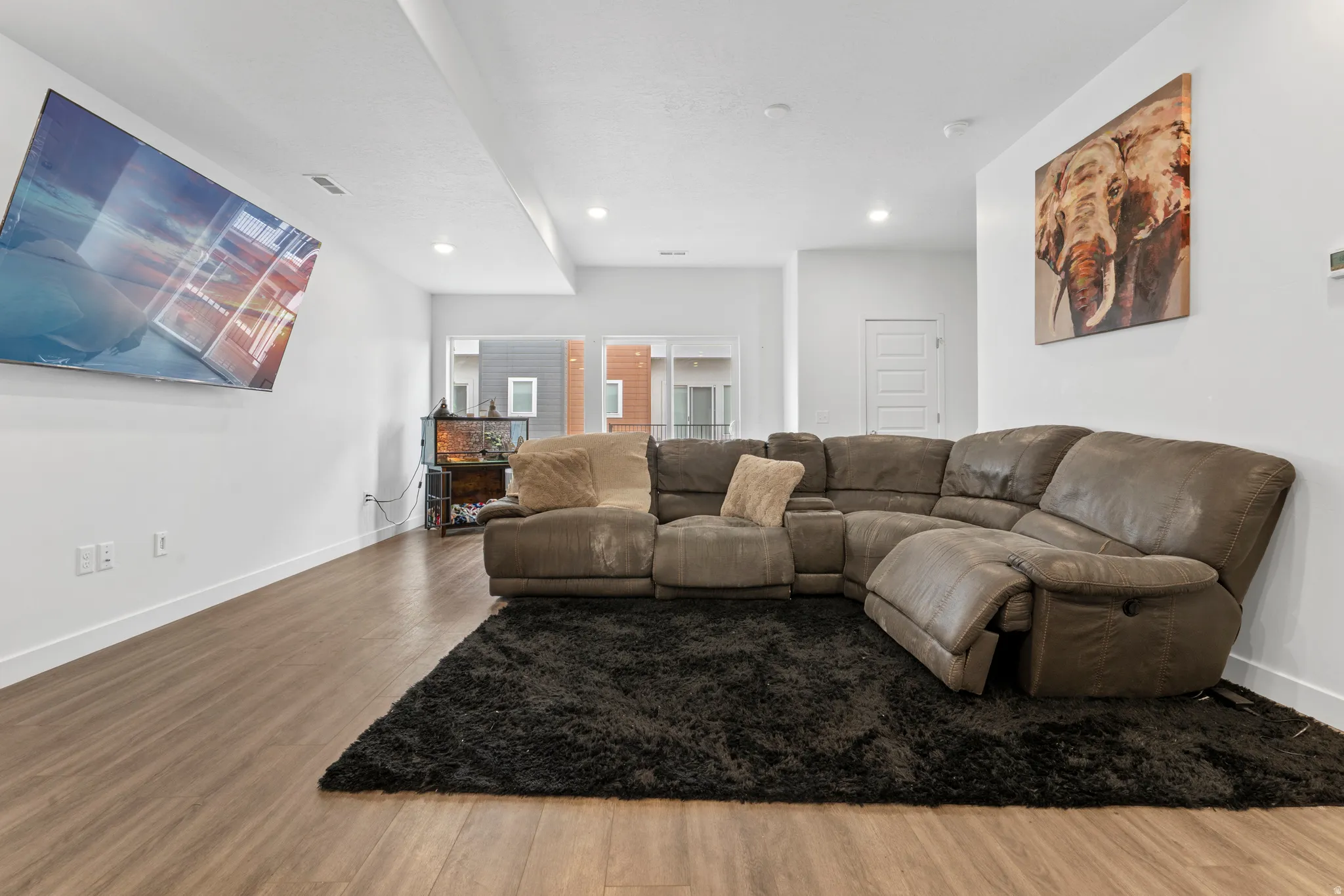 Living area featuring wood finished floors and recessed lighting