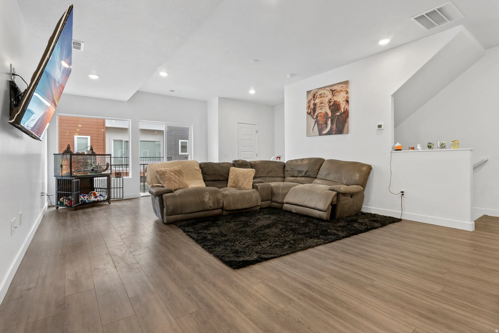 Living area featuring wood finished floors and recessed lighting