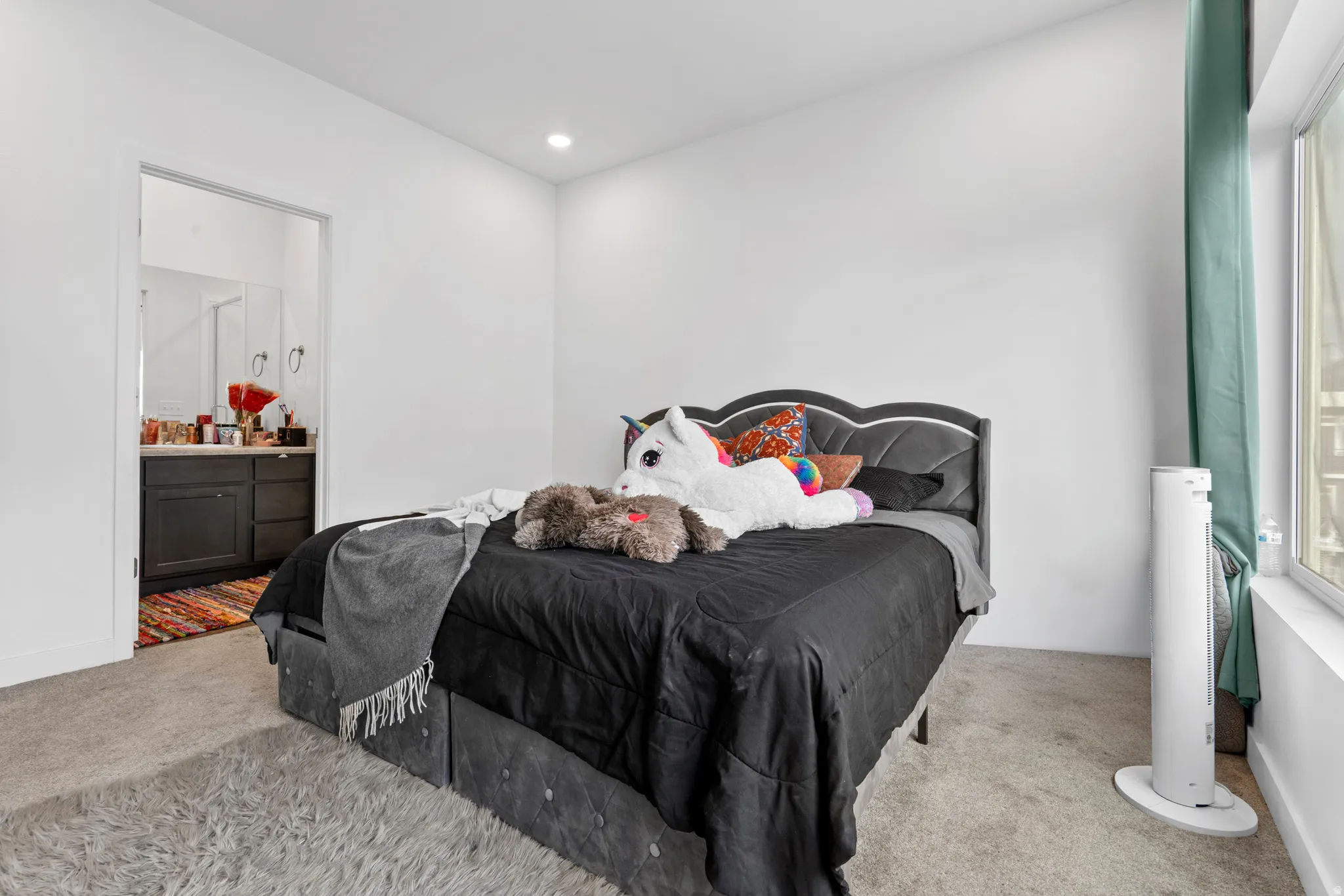 Bedroom featuring carpet flooring, ensuite bathroom, and recessed lighting