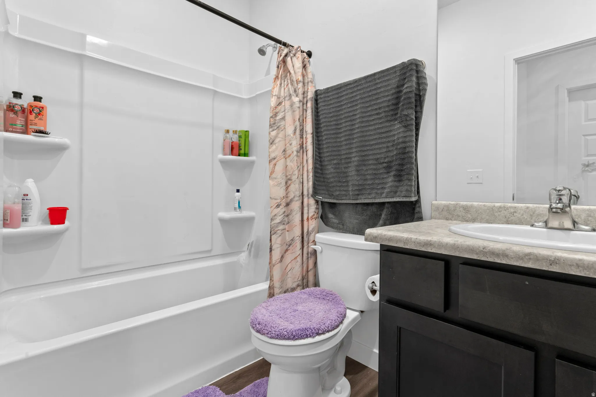 Bathroom featuring vanity and shower / tub combo