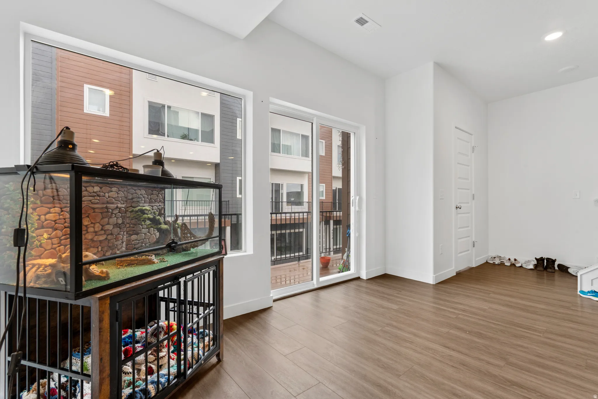 Unfurnished room with wood finished floors and recessed lighting