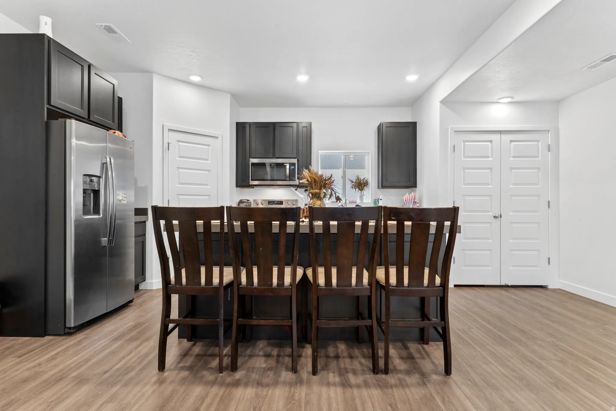 Dining area featuring light wood-type flooring and recessed lighting