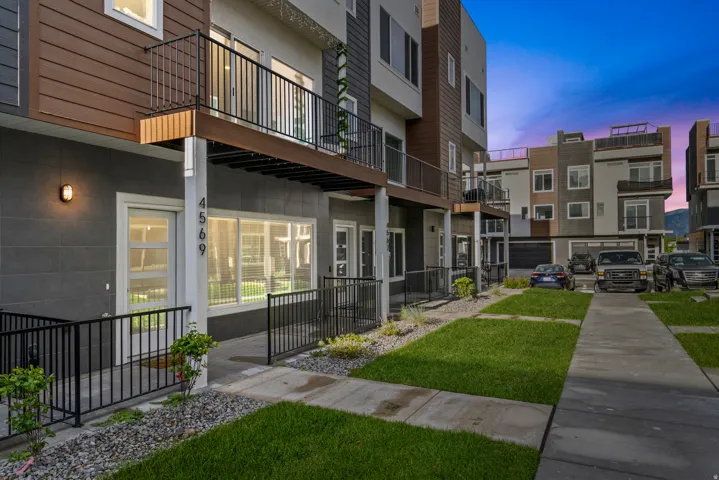 Property at dusk featuring a view of apartment building / complex