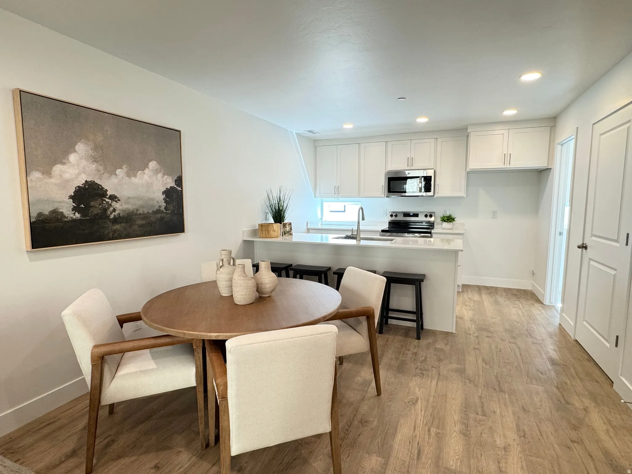 Dining room featuring light wood-type flooring and recessed lighting