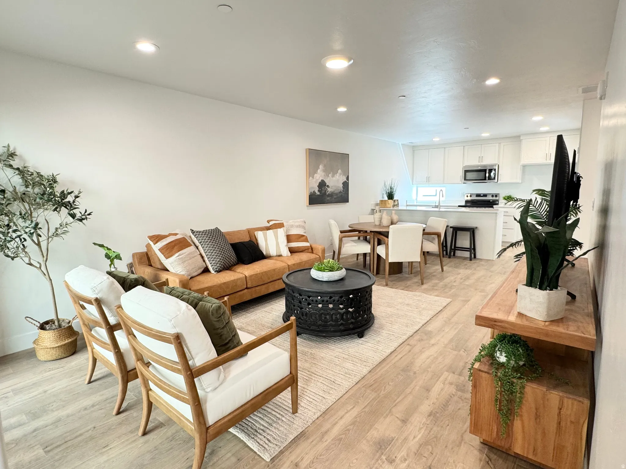 Living room with recessed lighting and light wood-style flooring