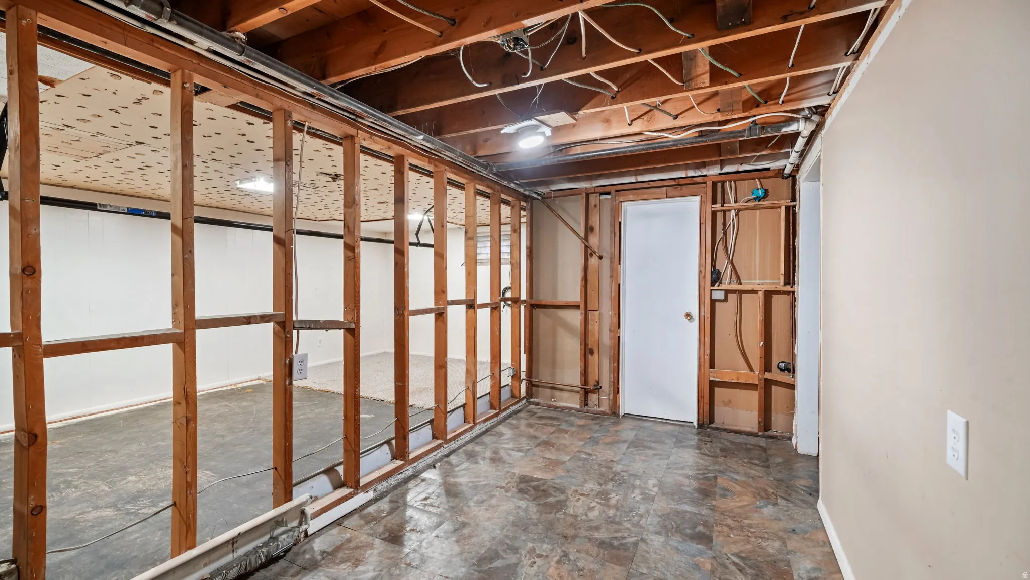 Unfinished below grade area featuring stone finish floors