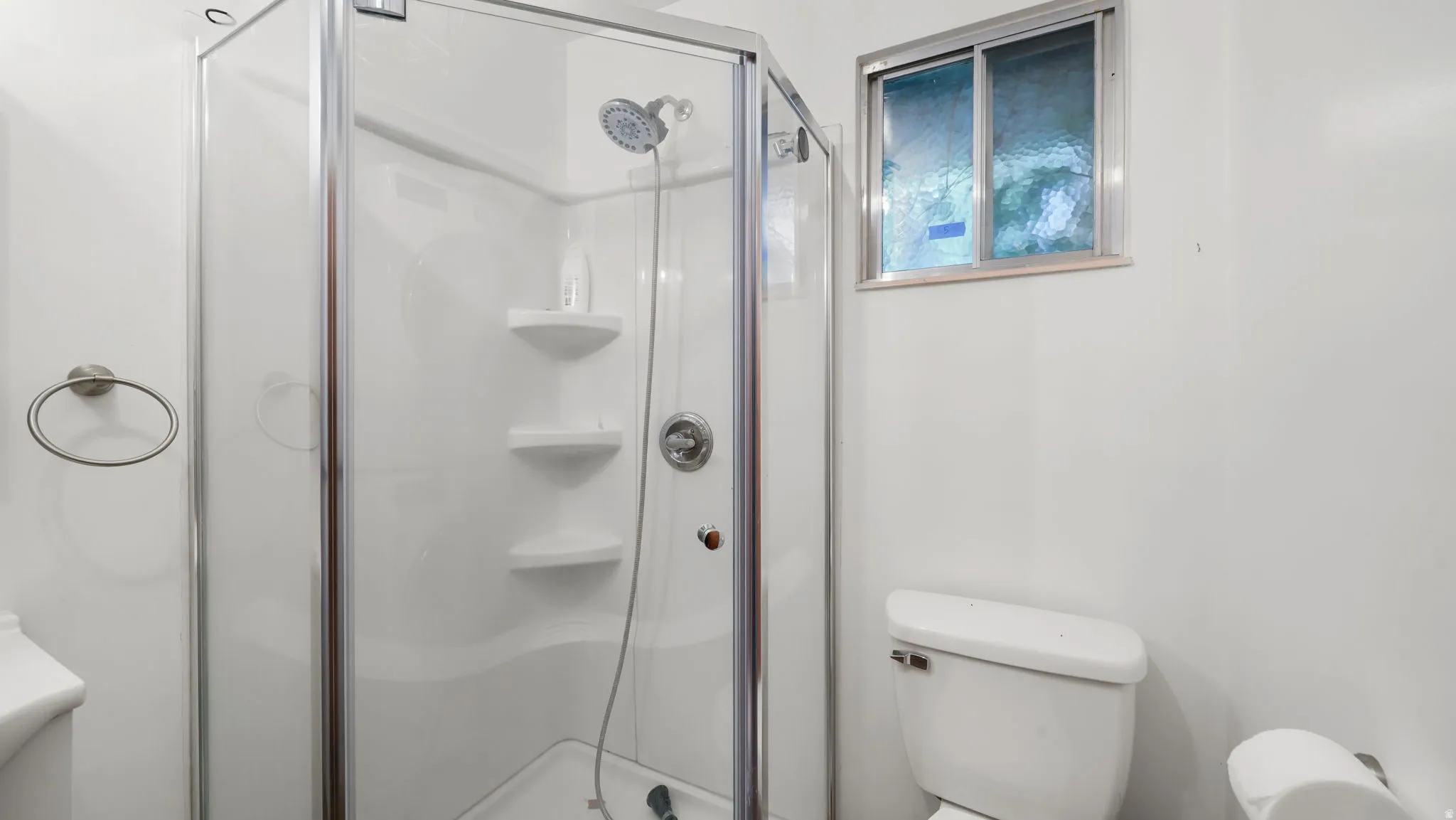 Bathroom with toilet and a stall shower