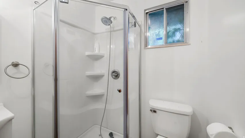 Bathroom with toilet and a stall shower