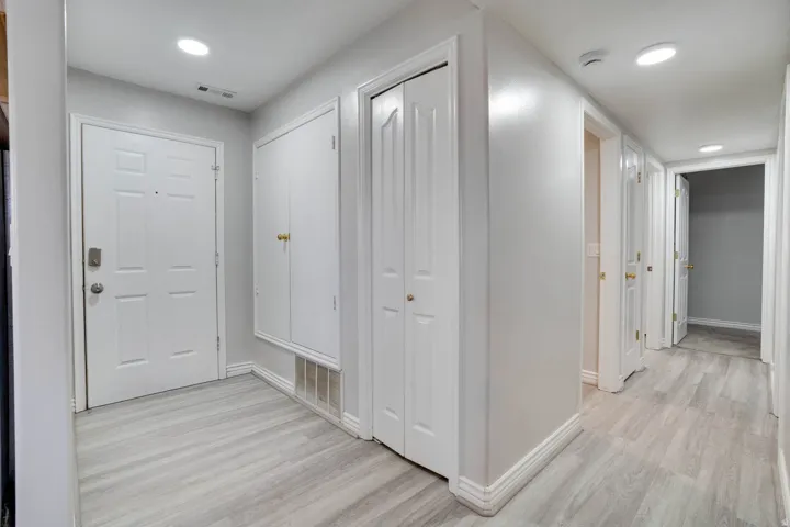 Corridor featuring light wood-style floors and recessed lighting