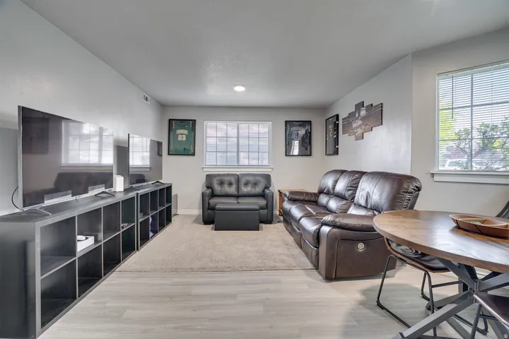 Living area with light wood-style flooring and plenty of natural light