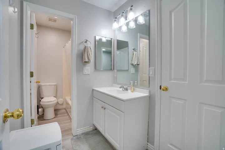 Bathroom featuring vanity and shower / tub combo with curtain