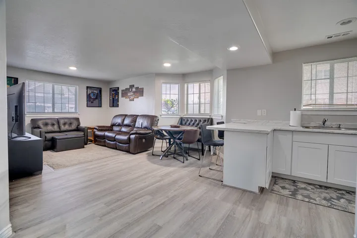 Living room featuring plenty of natural light, light wood-style floors, and recessed lighting