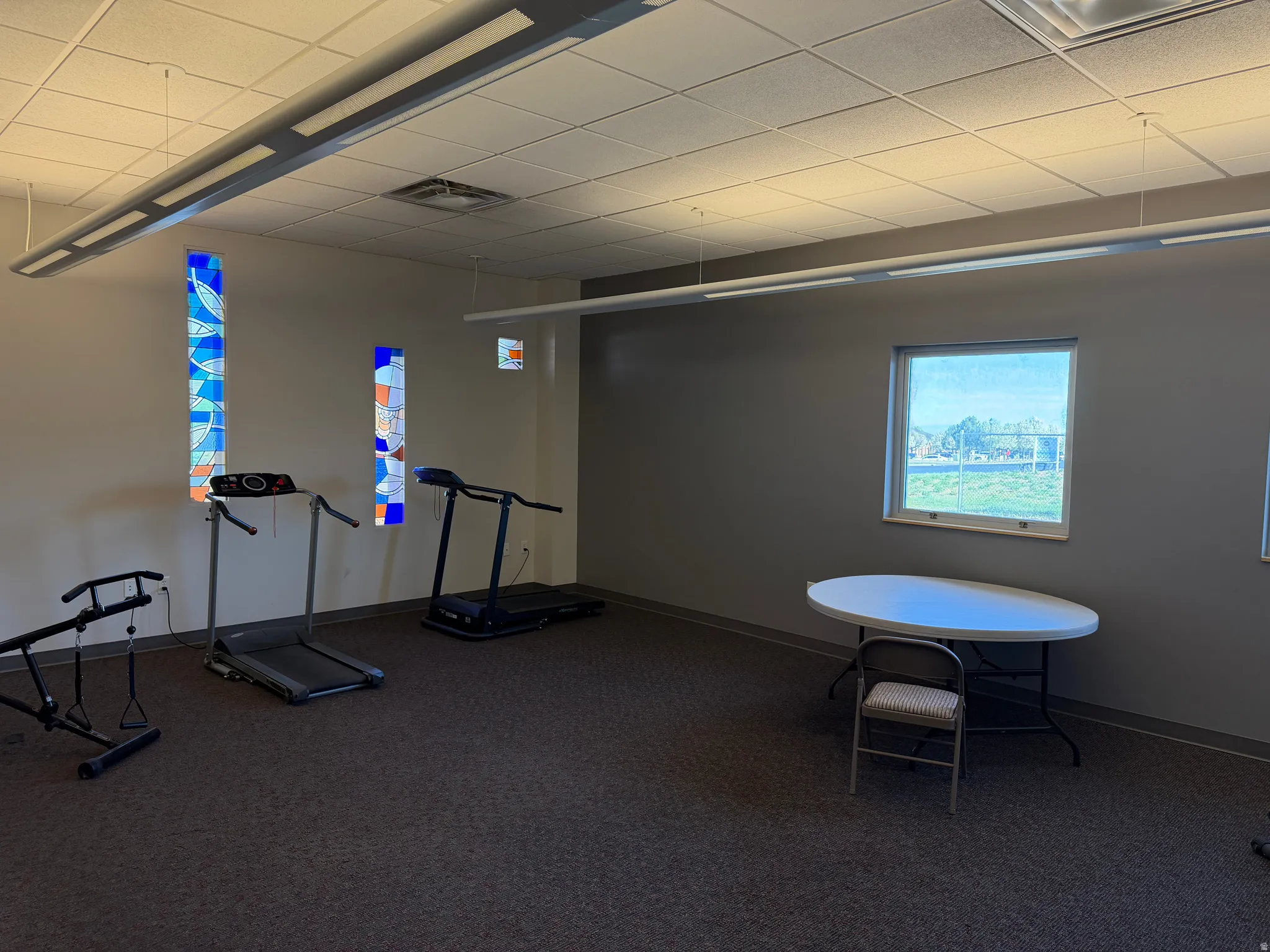 Exercise room with a paneled ceiling