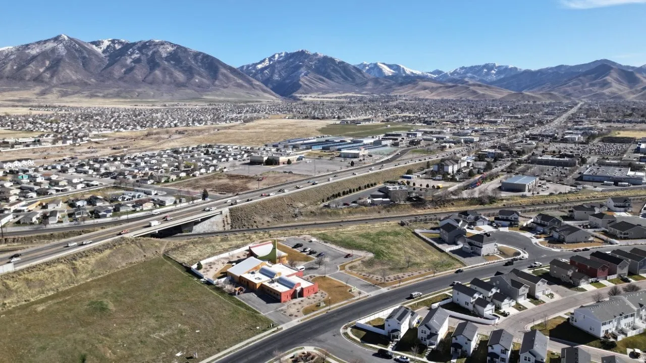 Aerial perspective of suburban area featuring a mountainous background