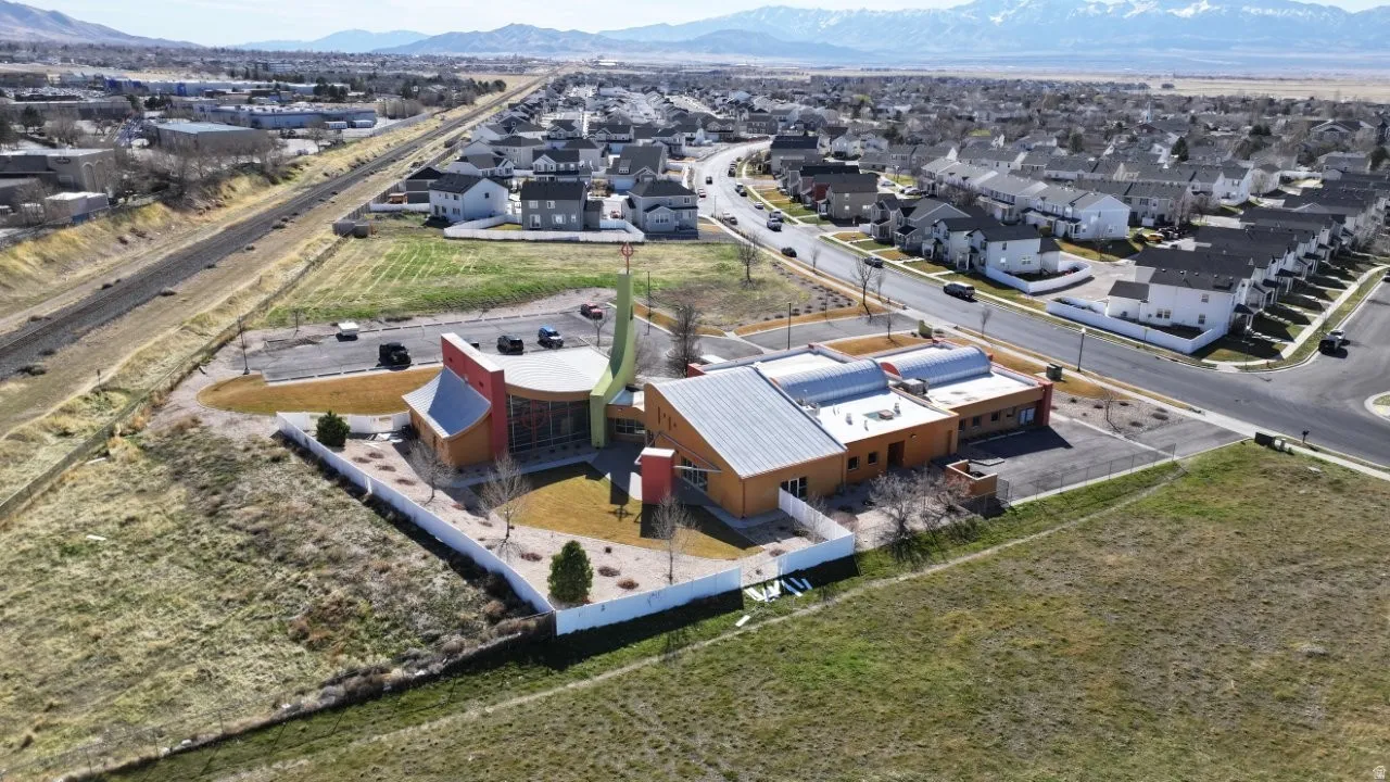 Aerial view of property's location with nearby suburban area and mountains