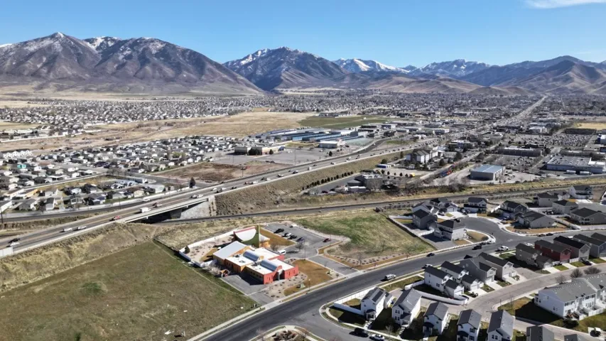 Aerial perspective of suburban area featuring a mountainous background