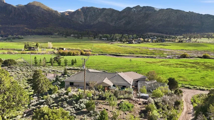 Aerial view of sparsely populated area with mountains and agricultural land
