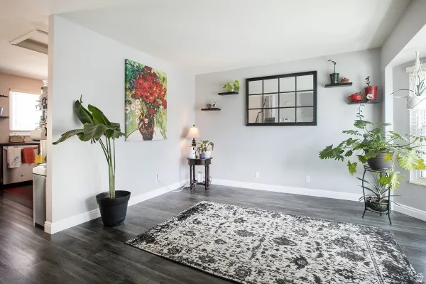 Unfurnished room featuring plenty of natural light and dark wood-style floors