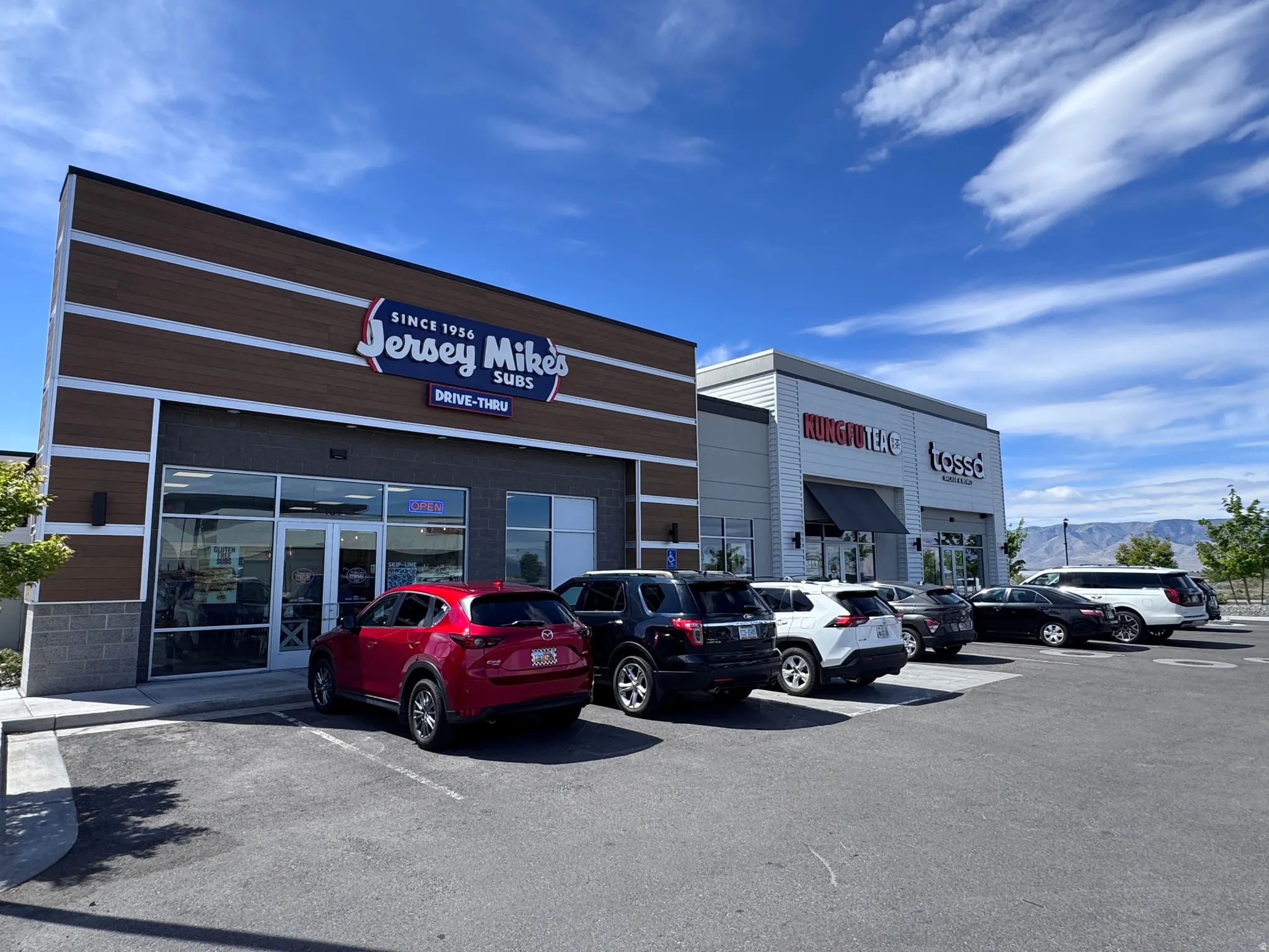 View of commercial property with uncovered parking