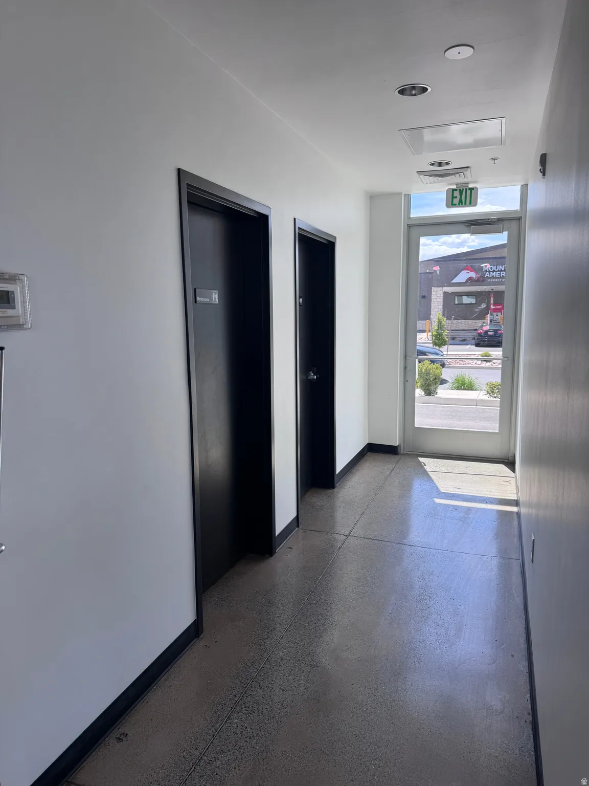 Hallway featuring baseboards and elevator