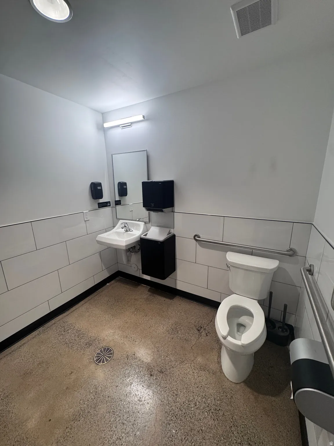 Bathroom featuring wainscoting and tile walls