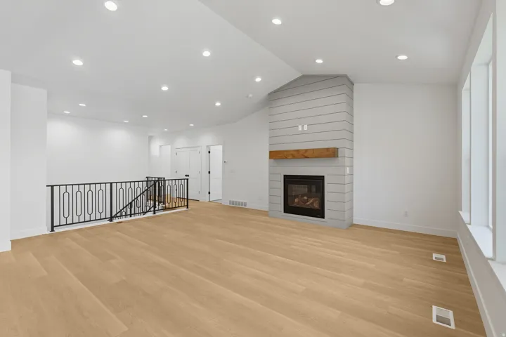 Unfurnished living room with light wood-style floors, a fireplace, and recessed lighting