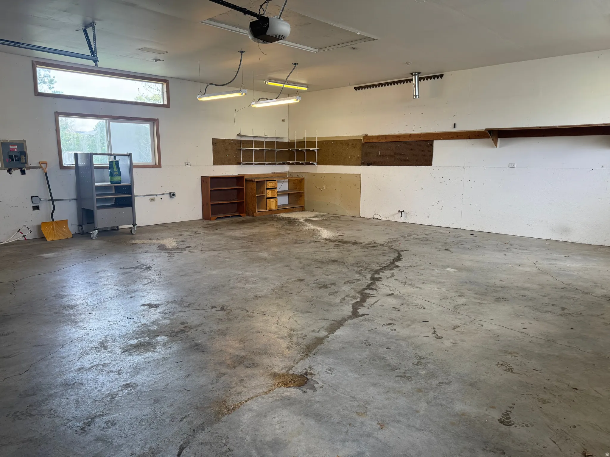 Garage with electric panel and a garage door opener