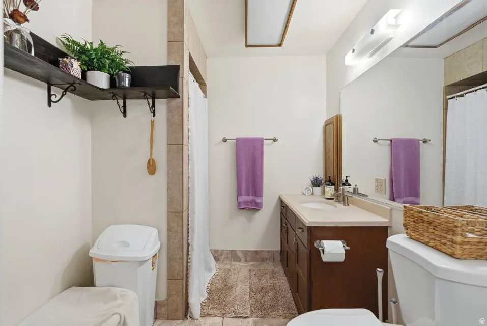 Bathroom with vanity and a shower with shower curtain