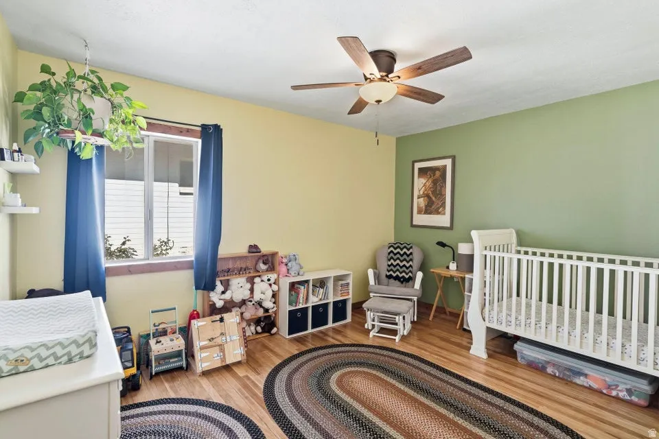 Bedroom featuring light wood-type flooring and a ceiling fan