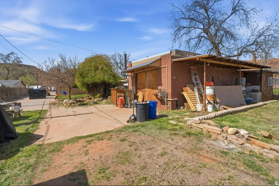 View of side of property featuring an outbuilding and a central AC unit