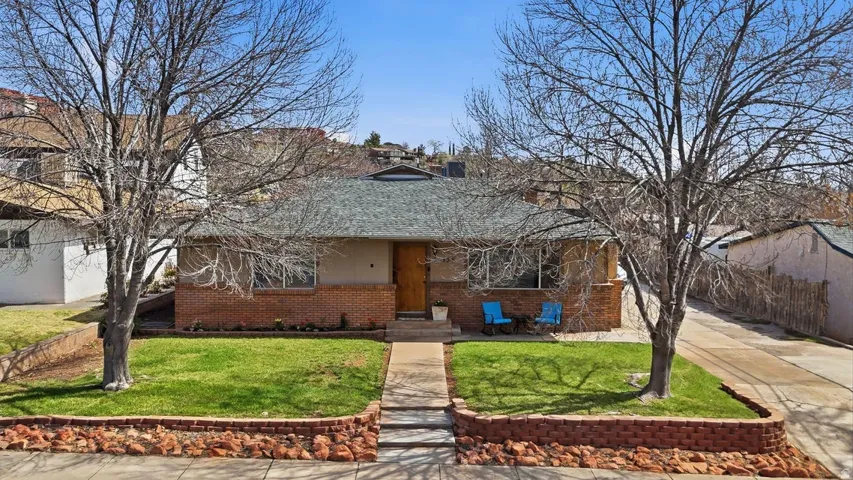 View of front of home featuring a porch and brick siding