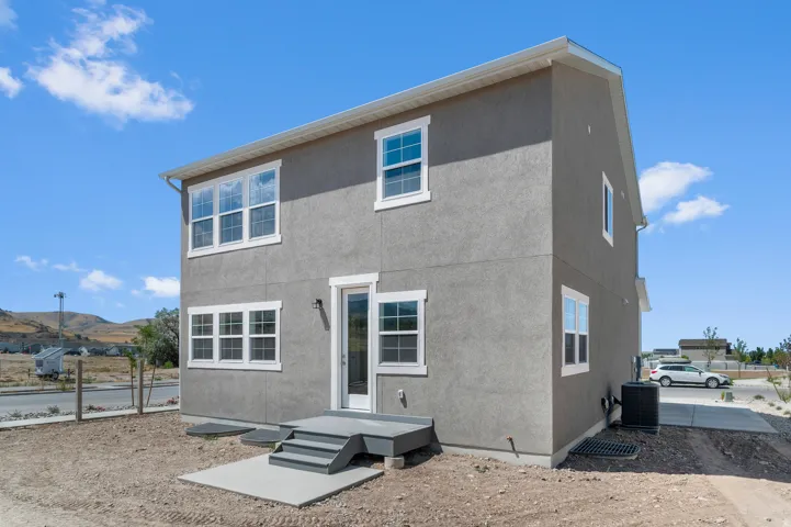 Two-story exterior with stucco finish and white trim