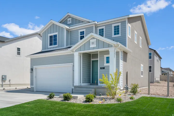 Modern two-story residence with a light gray siding and complementary stucco exterior