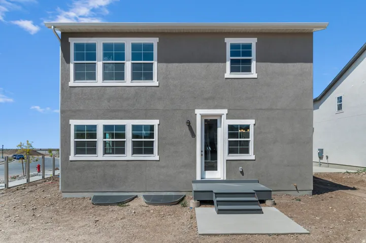 Rear exterior featuring gray stucco finish
