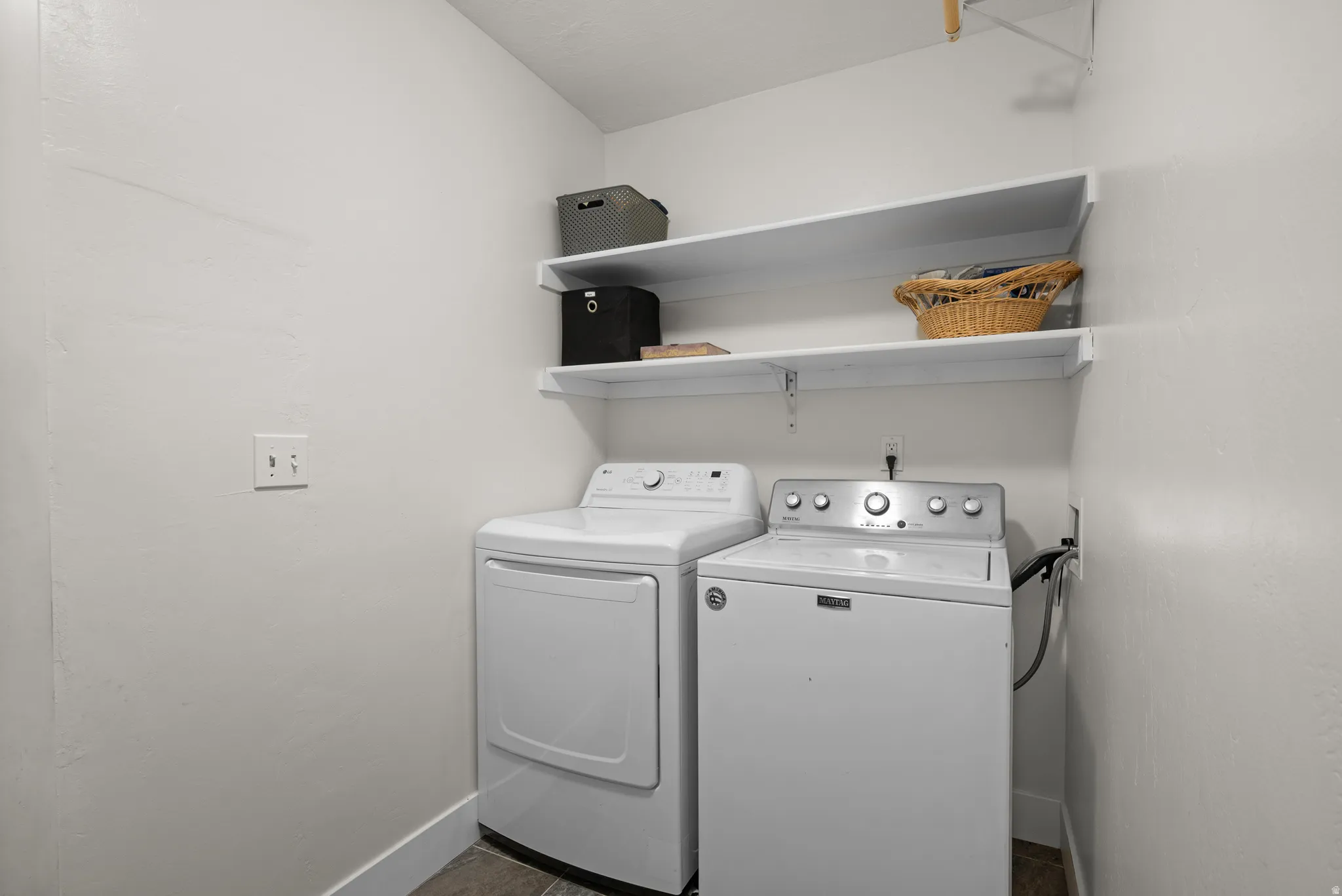 Laundry area featuring baseboards and washer and dryer