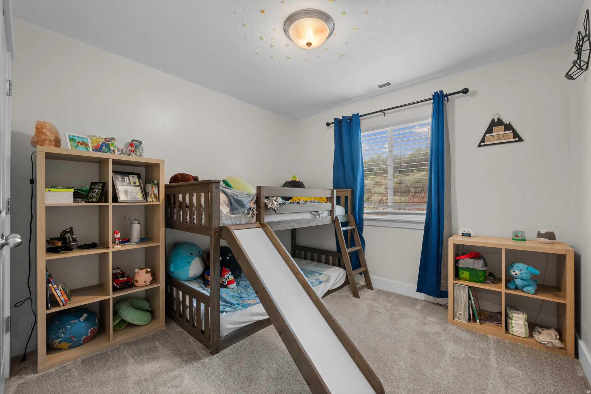 Bedroom with baseboards and light carpet