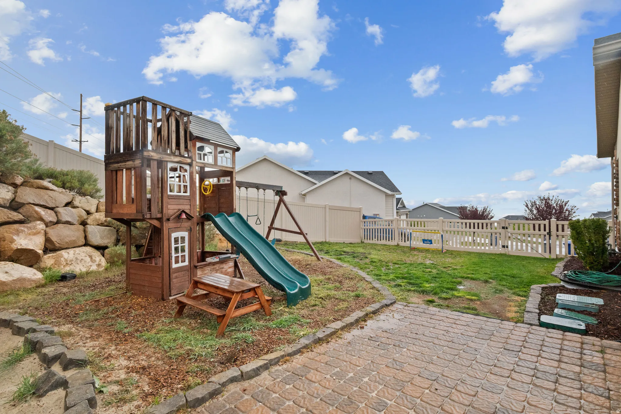 View of playground with a fenced backyard