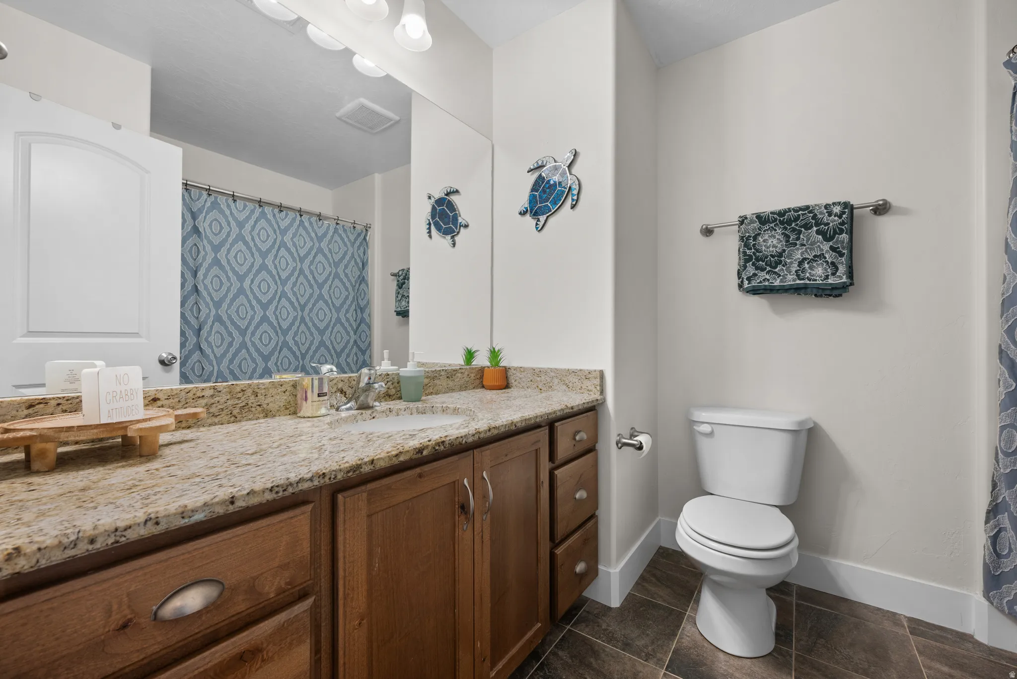 Bathroom featuring vanity and curtained shower