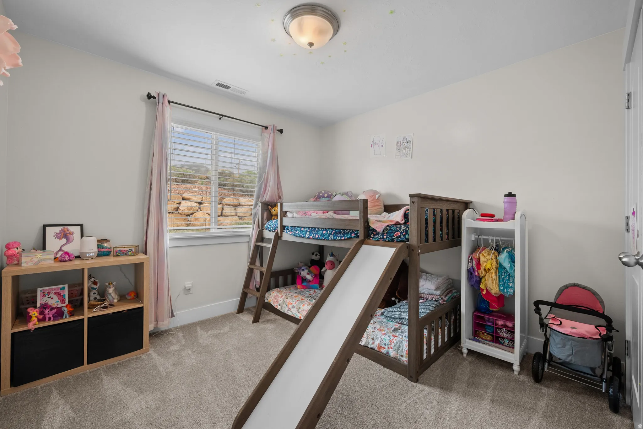 Bedroom featuring light carpet