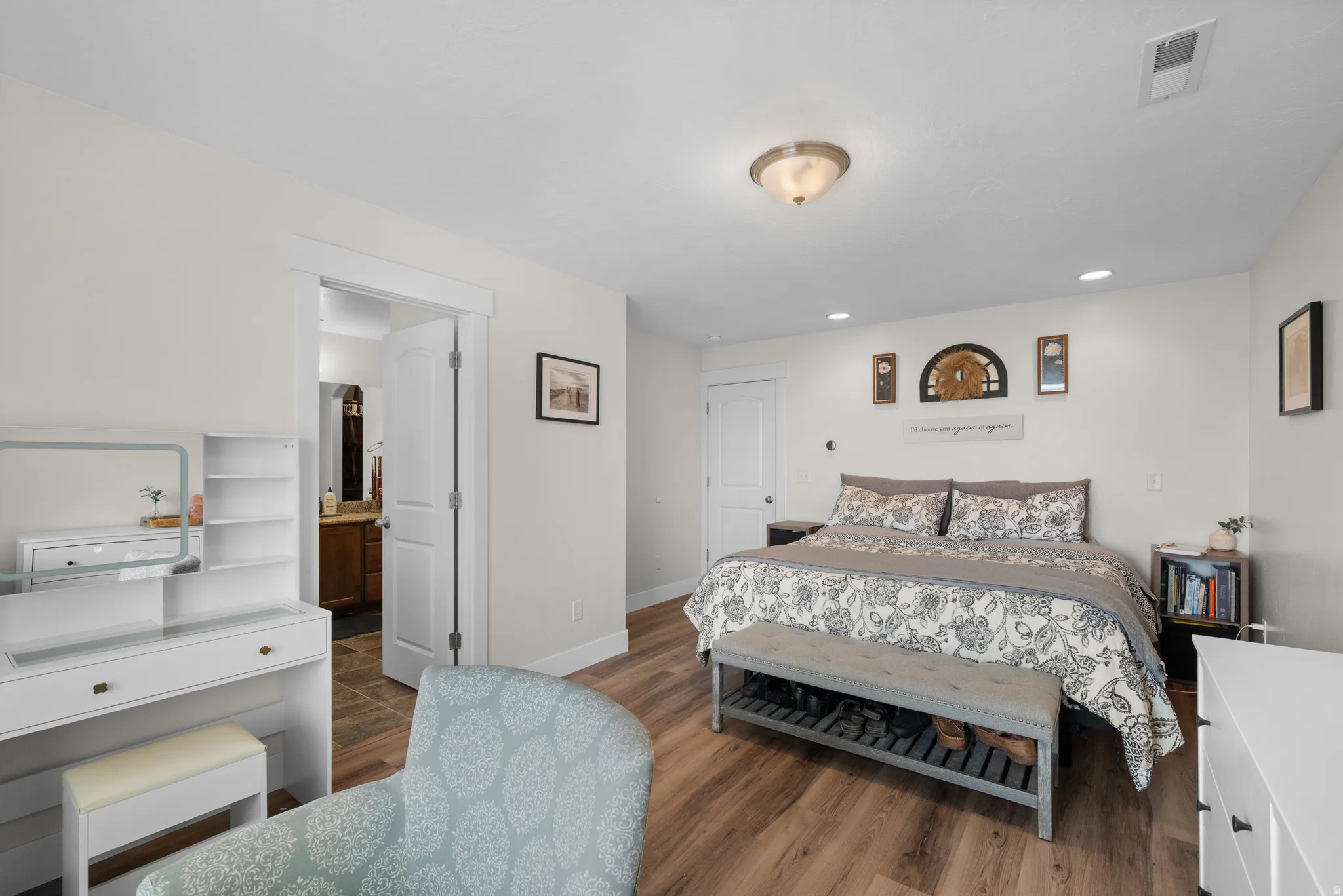 Bedroom with dark wood-style flooring, ensuite bath, and recessed lighting
