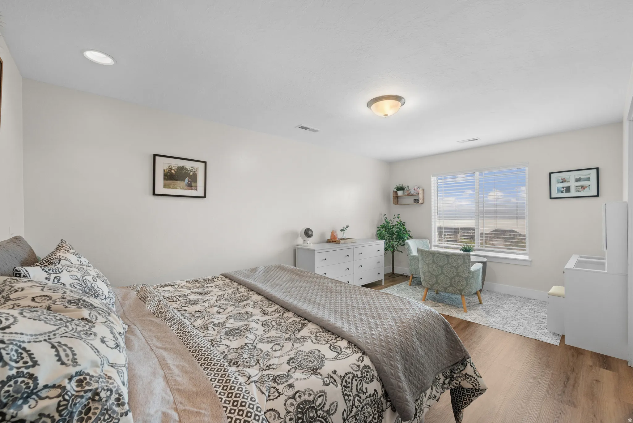 Bedroom with wood finished floors and baseboards