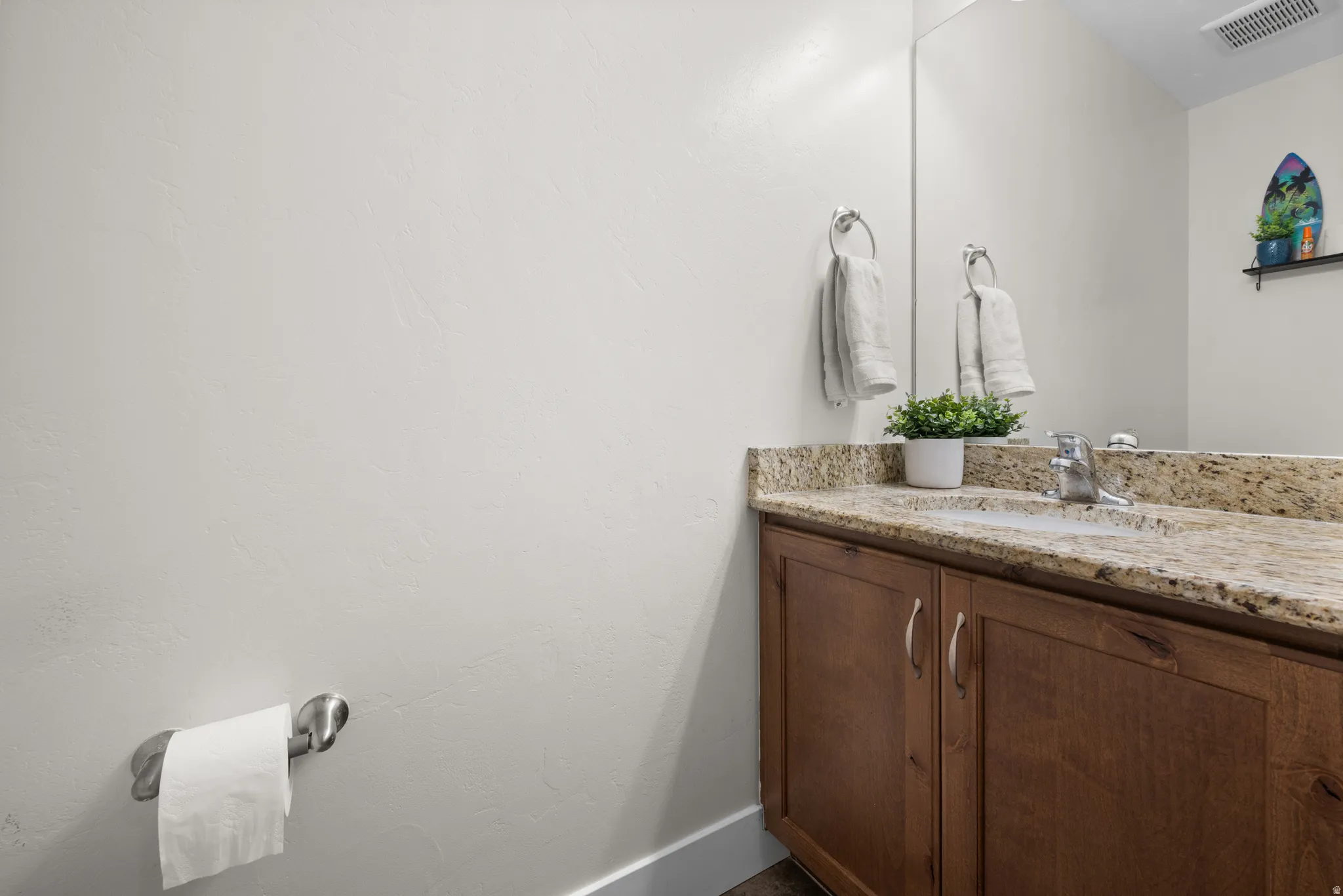 Bathroom featuring vanity and baseboards