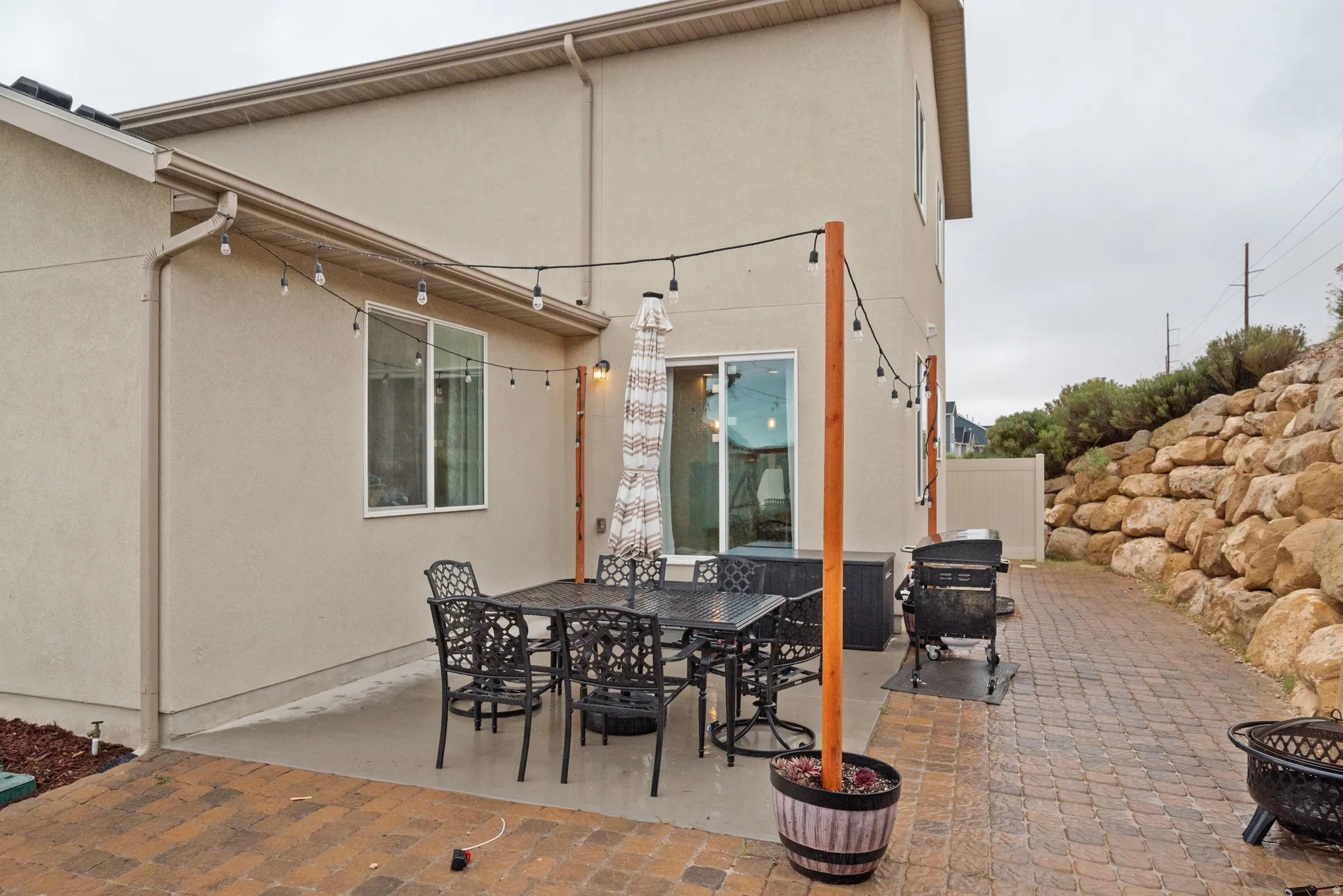 View of patio featuring outdoor dining space and a grill