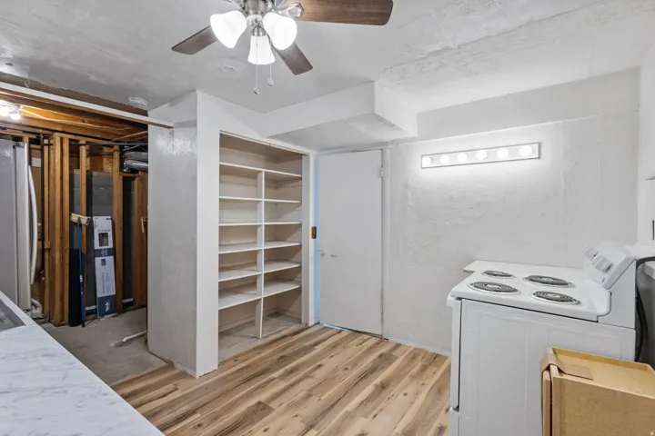 Built-in shelving unit providing extensive storage, complemented by wood-finish flooring